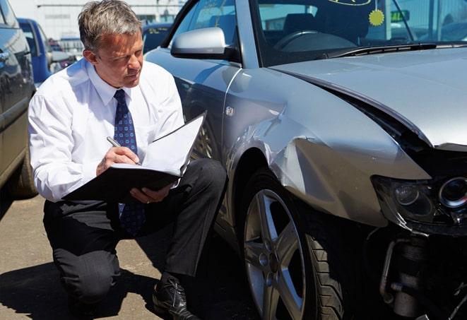 car accident on wet road with insurance adjuster